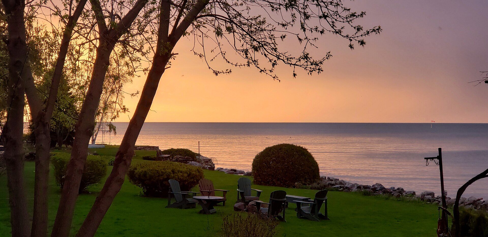 The southern shore of Georgian Bay at sunset, wide low horizon under a broad sky