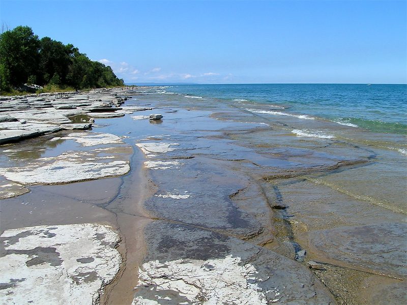 Flat rocky shoreline slabs at Craigleith Provincial Park meeting the water of Georgian Bay